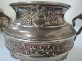 a silver vase that is sitting on a table