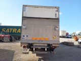 a truck that is parked in a lot with other trucks in the background