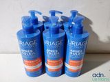 three bottles of uriage arges soleil lotion on a table