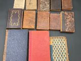several old books sitting on top of a table next to each other