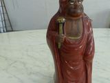 a figurine of a man with a cane on a table