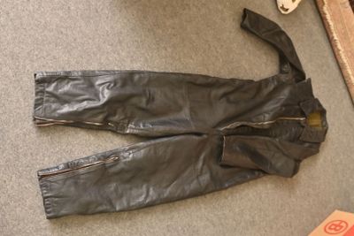 a pair of black leather pants laying on the floor