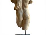 statue of a female torso on a marble base