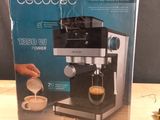 a box with a coffee maker on a table