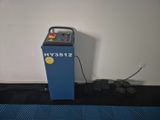a blue machine sitting on top of a blue mat next to a wall