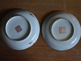 two plates that are sitting on a wooden table