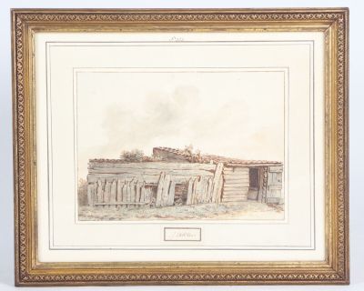 an old picture of a building in a frame on a table