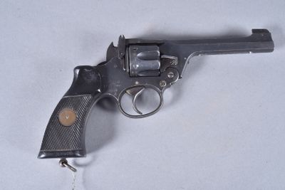 a gun that is sitting on a white surface