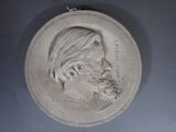 a plaque of a man with a beard on the wall