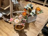 a vase of flowers sitting on a table next to a chair