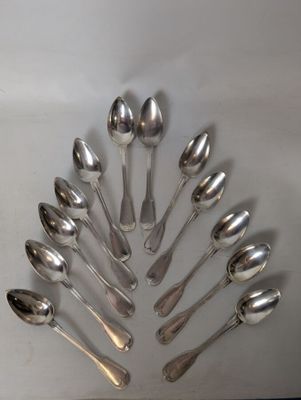 a lot of spoons arranged in a circle on the table
