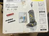 someone is holding a box with a vacuum cleaner on it