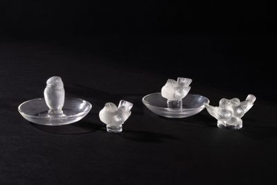 three pieces of glass sitting on top of a black table