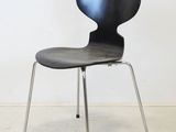 the chair is black and has a metal frame on the legs