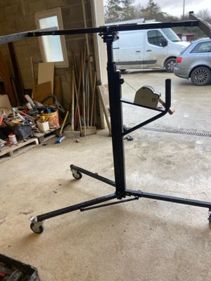 an image of a black metal stand with wheels in a garage