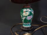 a lamp that is sitting on a table with a lamp shade on it