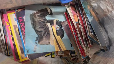 une pile de livres dans un sac en plastique, avec une paire de ciseaux