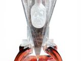 a glass vase with a bottle on top of it