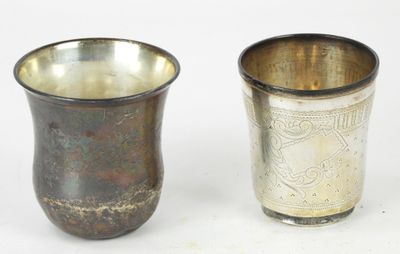 two cups sitting next to each other on a white surface