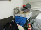 a pile of stuff on the floor next to a refrigerator