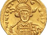 a close up of a gold coin with an image of a man