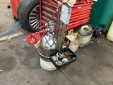 an image of a garage with a red toolbox and a red cart