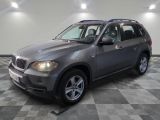 a picture of a silver bmw suv parked in a garage