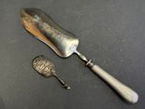 a silver spoon and a silver spoon on a black surface