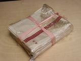 a wrapped package sitting on a table with a pink ribbon