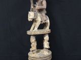 a statue of a man sitting on top of a stool