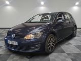 the blue volkswagen golf is parked on a checkered floor