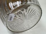 a glass vase with a label on it sitting on a table