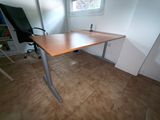 a desk with a chair in the corner of the room