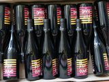bottles of wine sitting in a cardboard box on a shelf