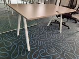 a table with chairs and a laptop on it in a conference room