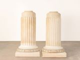 pair of white marble pedestals in the shape of columns