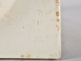 a close up of a white vase on a table