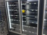 two refrigerators that are sitting in the middle of a store