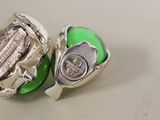 two green eggs with a silver clasp on them