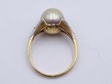 an image of a pearl and diamond ring on a white surface