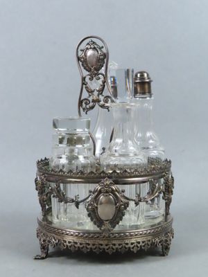 a silver plate with a glass decanter on top of it