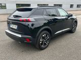 the rear end of a black suv parked in a parking lot