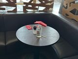 a table with a bottle of water on it in a booth