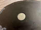 a close up view of a frying pan with a coin on it