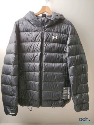 the jacket is hanging on a hanger in the corner of the room