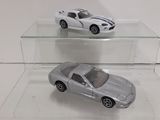 two toy cars on display in a clear display case