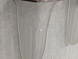 two wall sconces mounted on the side of a wall