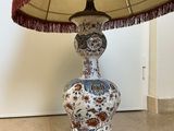 a lamp that is sitting on a table with a lamp shade on it