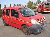 a red van parked in a parking lot with a firetruck in the background