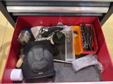 a red tool box with tools in it on the floor